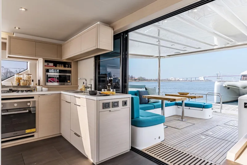 Slide: The Image of Modern kitchen and dining area on 2026 Lagoon 55 yacht with scenic water view. - 4