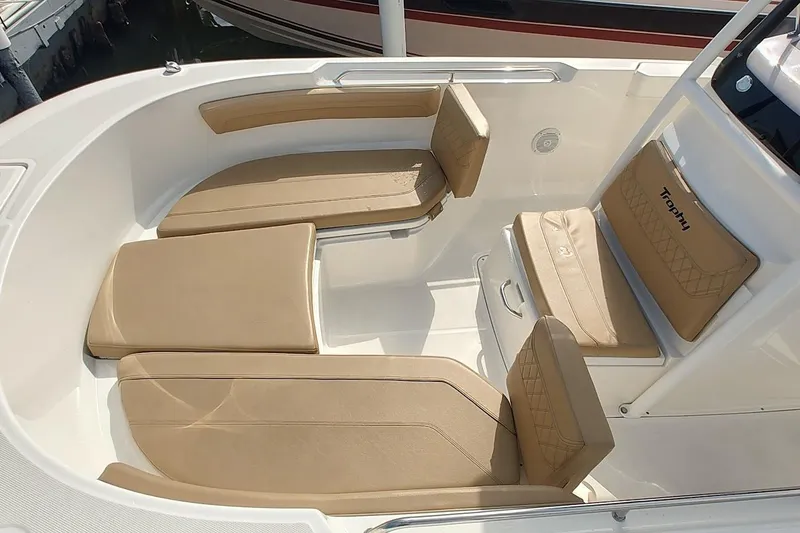Slide: The Image of 2024 Bayliner Trophy T24CC boat interior with beige cushioned seating. - 10