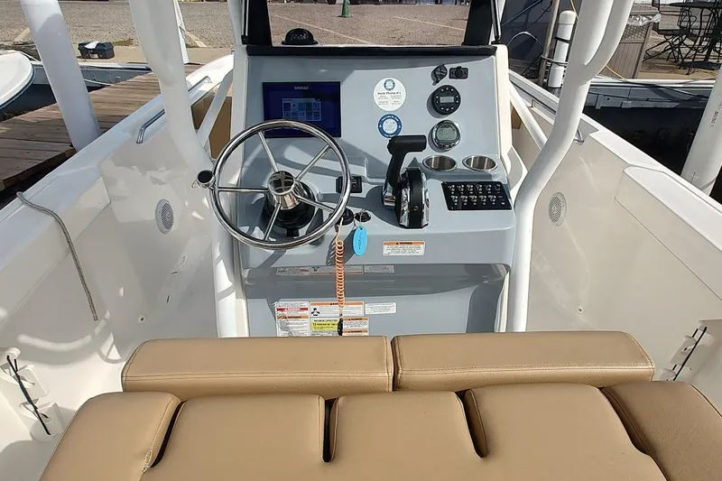 Slide: The Image of 2024 Bayliner Trophy T24CC boat helm with steering wheel and controls. - 11