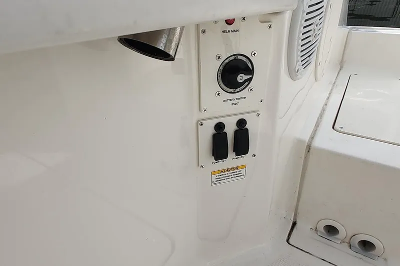 Slide: The Image of 2024 Bayliner Trophy T24CC boat control panel with battery switch and pump controls. - 16