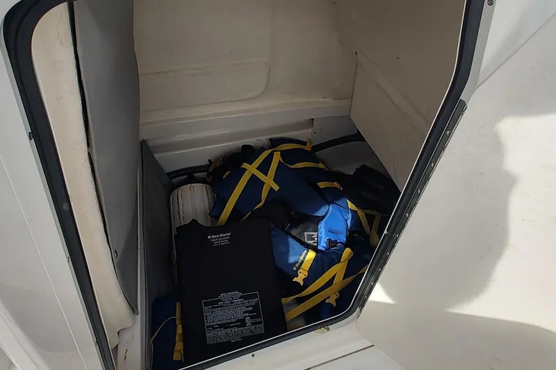 Slide: The Image of Storage compartment with life jackets in 2024 Bayliner Trophy T24CC boat. - 17