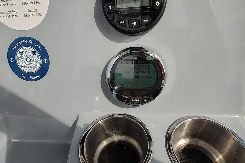 Slide: The Image of 2024 Bayliner Trophy T24CC dashboard with gauges, QR code, and cup holders. - 19