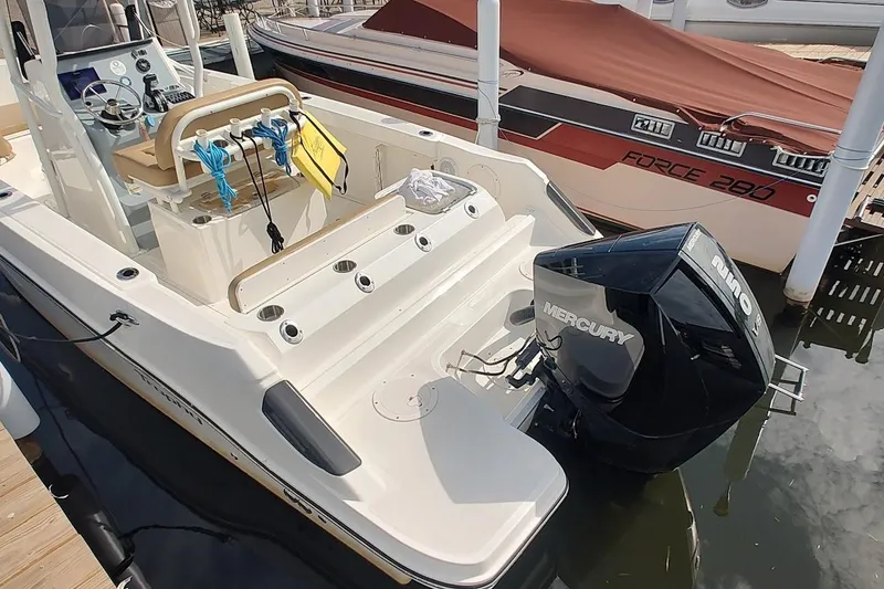 Slide: The Image of 2024 Bayliner Trophy T24CC boat with Mercury outboard engine docked at marina. - 4