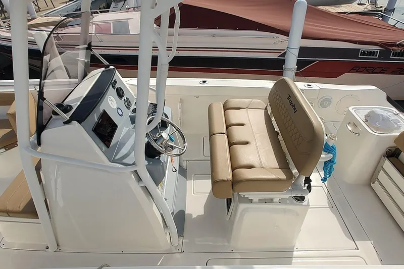 Slide: The Image of 2024 Bayliner Trophy T24CC boat interior with helm and seating area. - 7