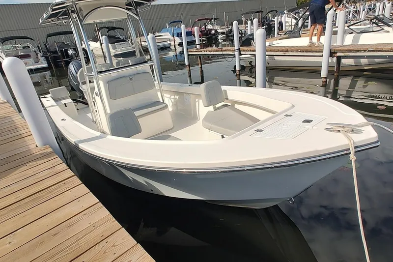 The Image of 2024 May-Craft 23 Cape Classic boat docked at marina, showcasing sleek design and spacious seating. - 0