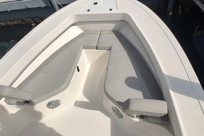 Slide: The Image of 2024 May-Craft 23 Cape Classic boat interior with cushioned seating and speaker. - 11