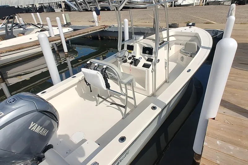 Slide: The Image of 2024 May-Craft 23 Cape Classic boat docked, featuring Yamaha engine and center console. - 3