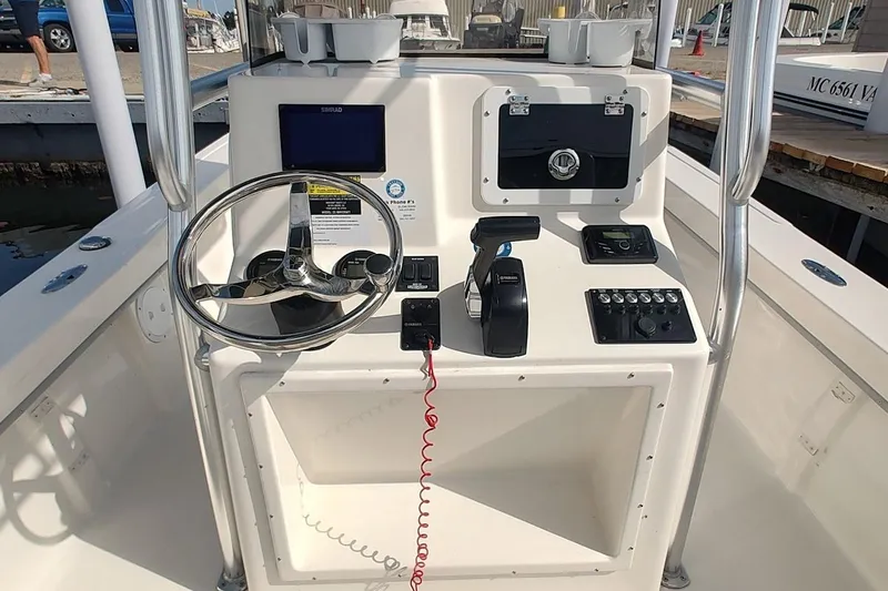 Slide: The Image of 2024 May-Craft 23 Cape Classic boat console with steering wheel and controls. - 7