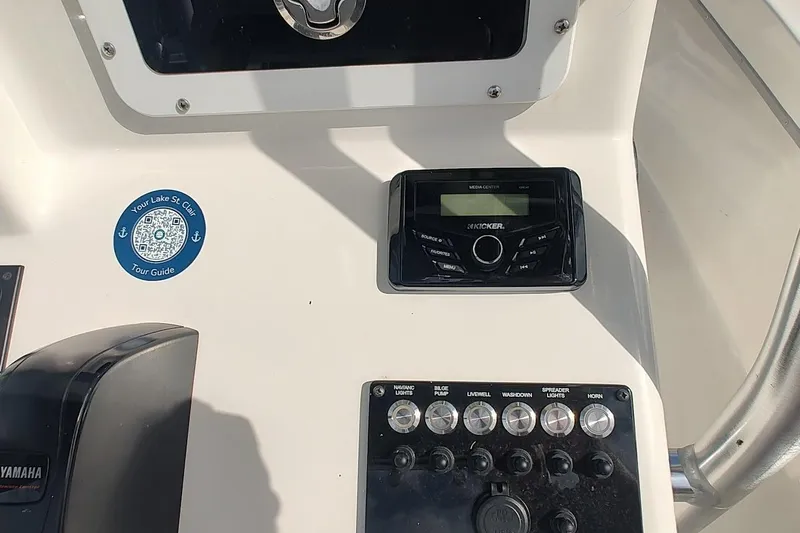Slide: The Image of Control panel of 2024 May-Craft 23 Cape Classic boat with audio system and switches. - 9