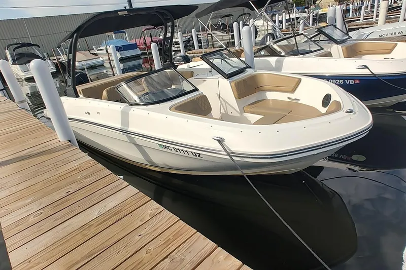 The Image of 2024 Bayliner VR6 Bowrider OB docked, showcasing sleek design and spacious seating. - 0