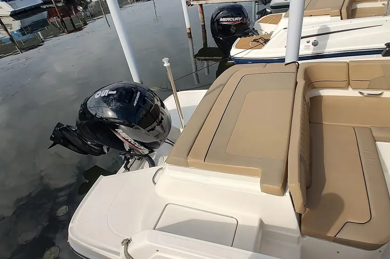 Slide: The Image of 2024 Bayliner VR6 Bowrider OB with Mercury outboard engine, docked by the water. - 4