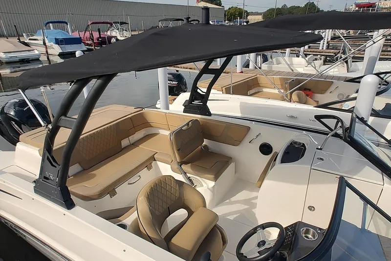 Slide: The Image of 2024 Bayliner VR6 Bowrider OB with spacious seating and sleek design at a marina. - 5
