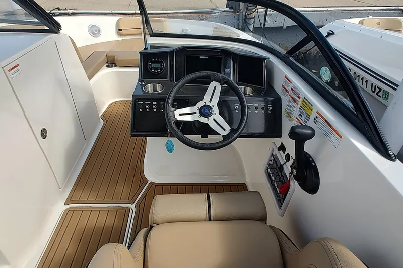 Slide: The Image of 2025 Bayliner VR6 Bowrider OB cockpit with modern steering and controls. - 2