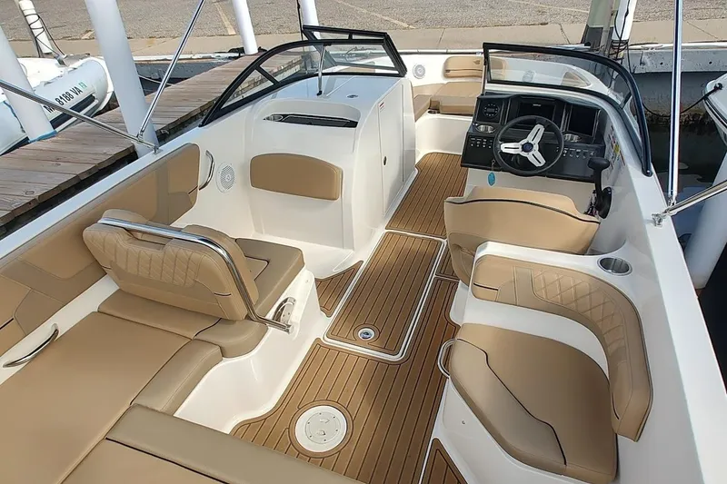 Slide: The Image of 2025 Bayliner VR6 Bowrider OB interior with tan seating and modern dashboard. - 3