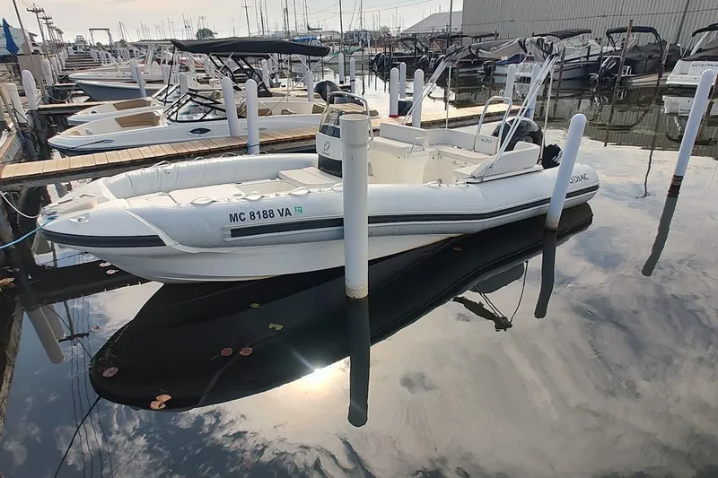 The Image of 2024 Zodiac N-ZO 680 boat docked in a marina, surrounded by other vessels. - 0
