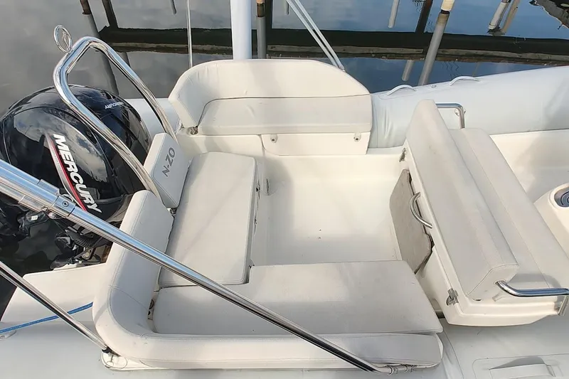 Slide: The Image of 2024 Zodiac N-ZO 680 boat interior with seating and Mercury engine. - 5