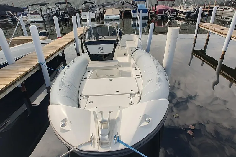 Slide: The Image of 2024 Zodiac N-ZO 680 boat docked at marina, featuring sleek design and spacious deck. - 8