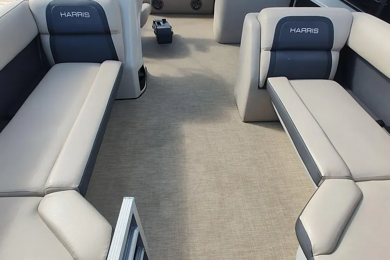 Slide: The Image of 2024 Harris Cruiser 230 interior with beige and gray seating, spacious layout. - 9