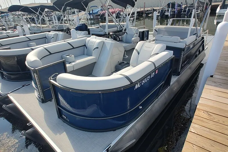 The Image of 2023 Crest Classic LX 220 pontoon boat docked, featuring spacious seating and modern design. - 0