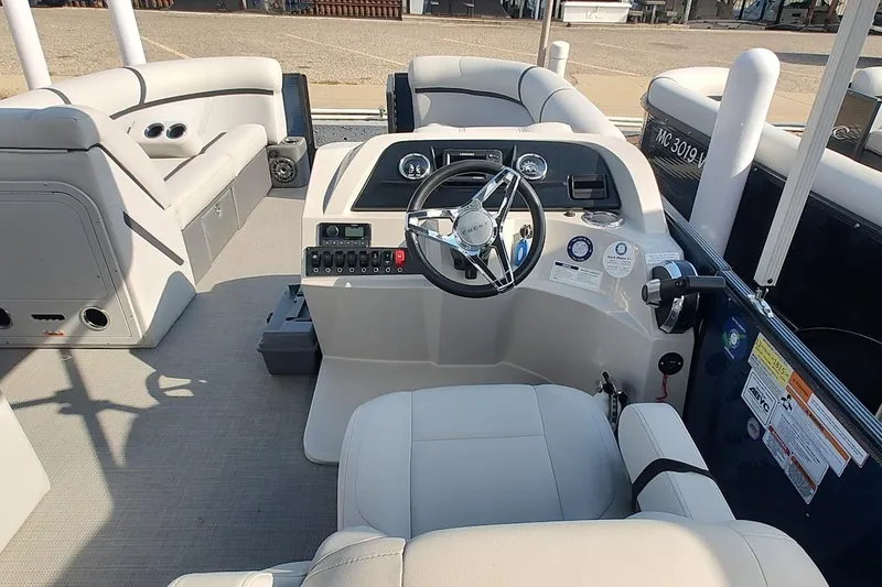 Slide: The Image of 2023 Crest Classic LX 220 boat interior with steering wheel and seating. - 10
