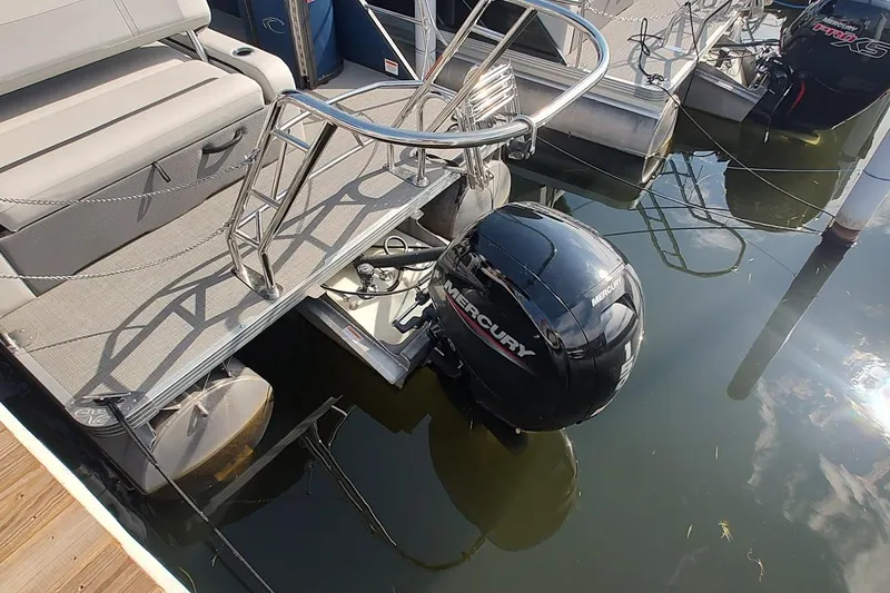 Slide: The Image of 2023 Crest Classic LX 220 pontoon boat with Mercury outboard motor at dock. - 6