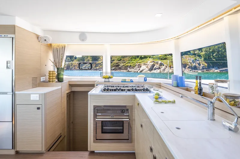 Slide: The Image of Modern kitchen interior of 2026 Lagoon 43 yacht with scenic ocean view. - 11