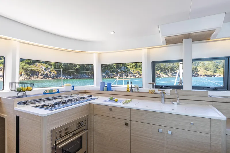 Slide: The Image of Modern kitchen interior on 2026 Lagoon 43 yacht with scenic ocean view. - 12