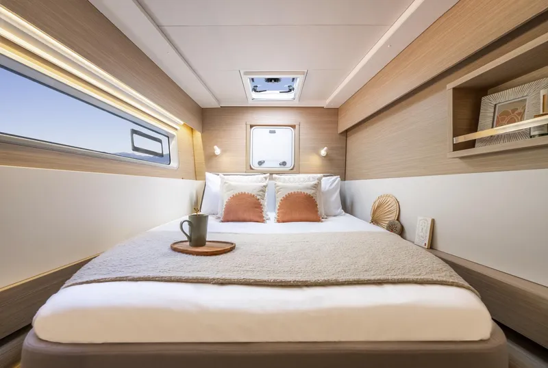Slide: The Image of Luxurious cabin interior of 2026 Lagoon 43 yacht with cozy bed and modern decor. - 13
