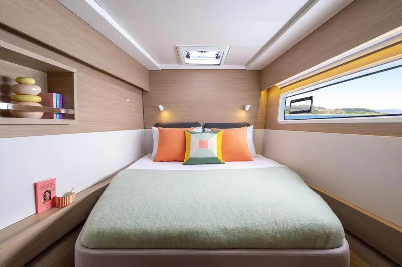 Slide: The Image of Luxurious cabin interior of 2026 Lagoon 43 yacht with modern decor and scenic window view. - 14