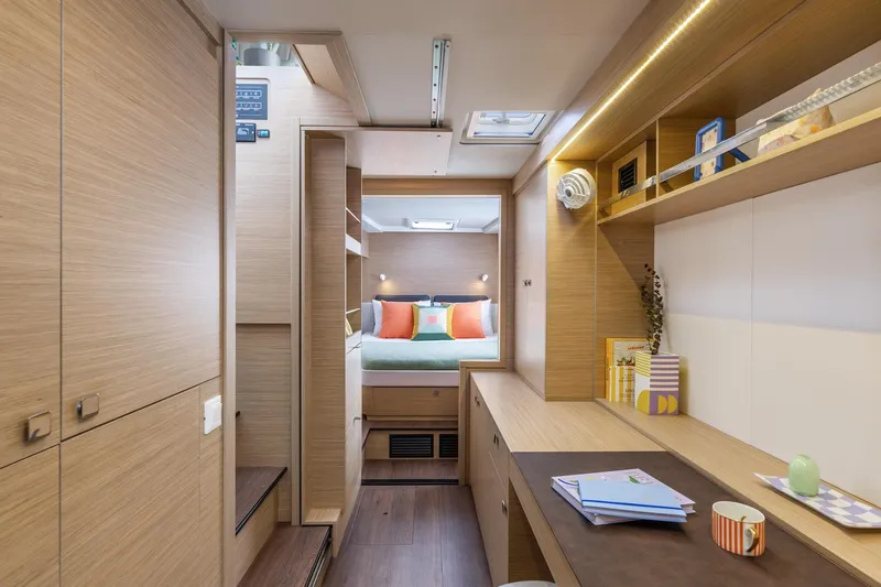 Slide: The Image of Luxurious interior of 2026 Lagoon 43 yacht with modern wood finish and cozy bedroom. - 15