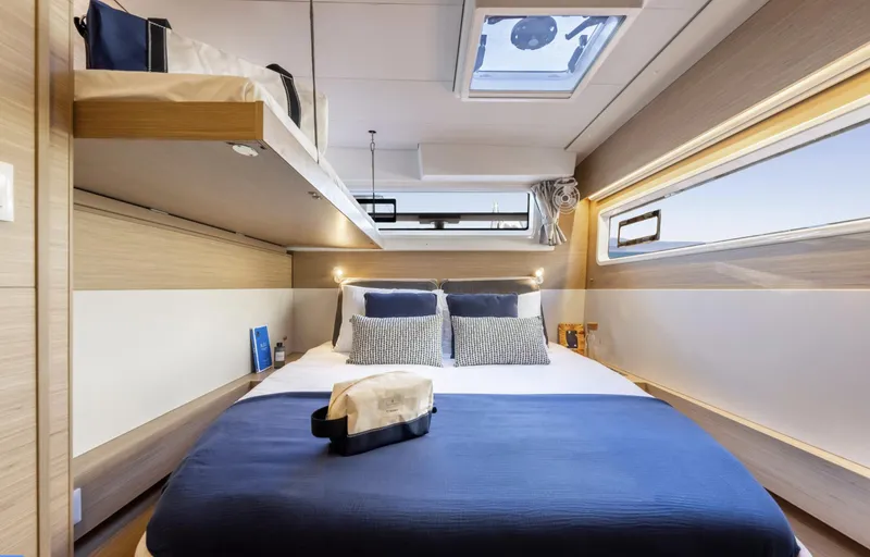 Slide: The Image of Luxurious cabin interior of 2026 Lagoon 43 yacht with modern bedding and natural light. - 16