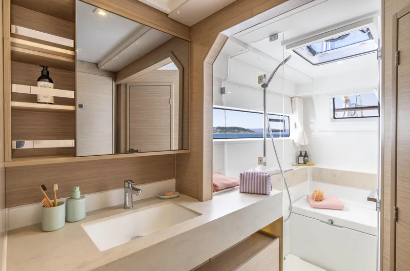 Slide: The Image of Luxurious bathroom interior of 2026 Lagoon 43 yacht with modern fixtures and ocean view. - 17
