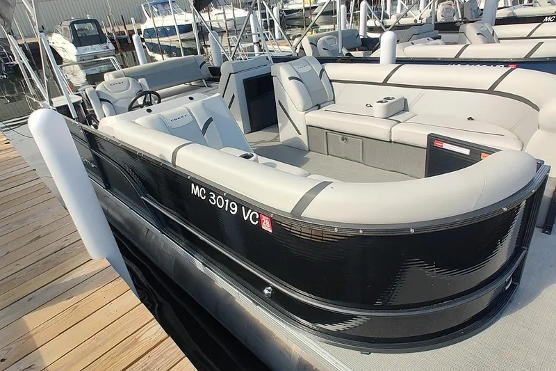 The Image of 2024 Crest Classic LX 220 pontoon boat docked, featuring sleek design and comfortable seating. - 0