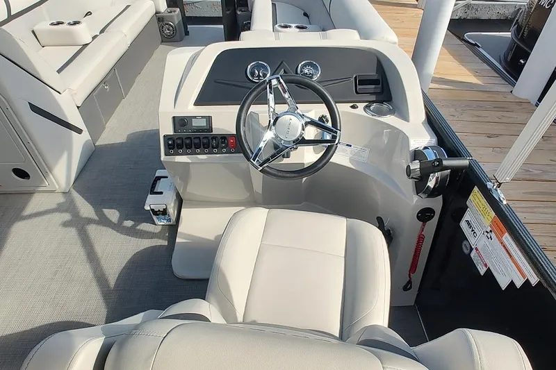 Slide: The Image of 2024 Crest Classic LX 220 boat interior with steering wheel and control panel. - 5