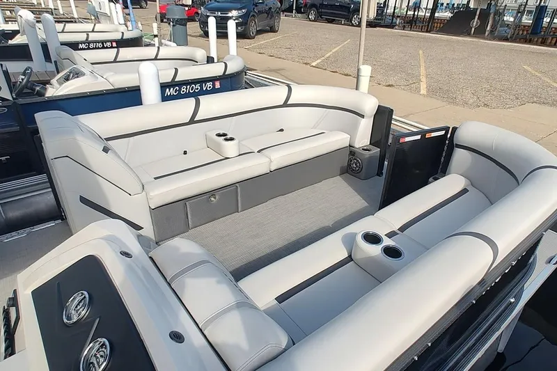 Slide: The Image of 2024 Crest Classic LX 220 pontoon boat with spacious seating and cup holders. - 8