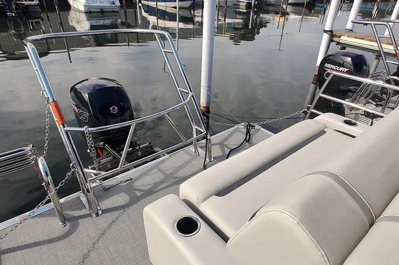 Slide: The Image of 2024 Crest Classic LX 220 pontoon boat with Mercury outboard motor at dock. - 9