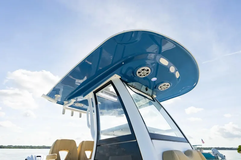 Slide: The Image of 2026 Sportsman Masters 267OE Bay Boat with sleek blue canopy and modern design. - 8