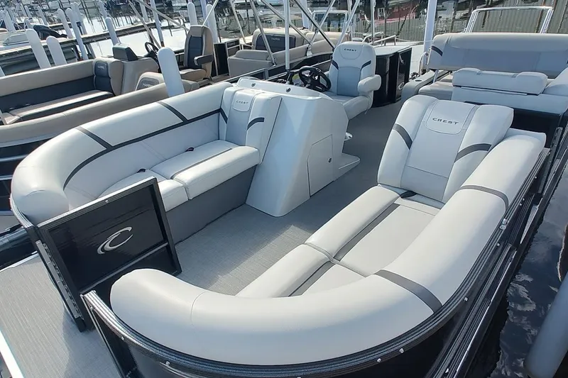 Slide: The Image of 2023 Crest Classic LX 220 pontoon boat interior with luxurious seating and modern helm. - 4
