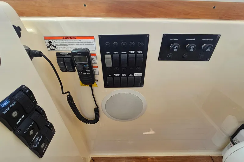 Slide: The Image of 2009 Sabre 42 Express boat on calm water, surrounded by lush greenery. - 10