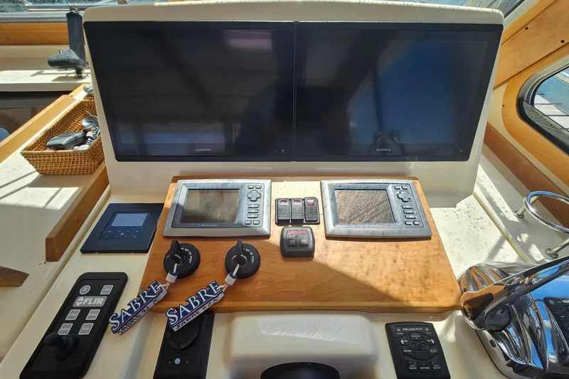 Slide: The Image of 2009 Sabre 42 Express yacht cruising on a serene blue lake. - 11