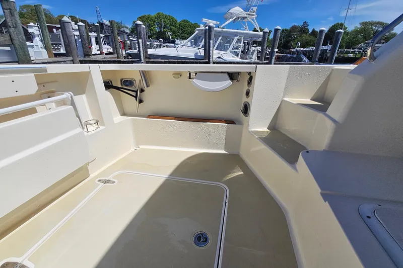 Slide: The Image of 2009 Sabre 42 Express yacht docked in marina, showcasing sleek design and spacious deck. - 21