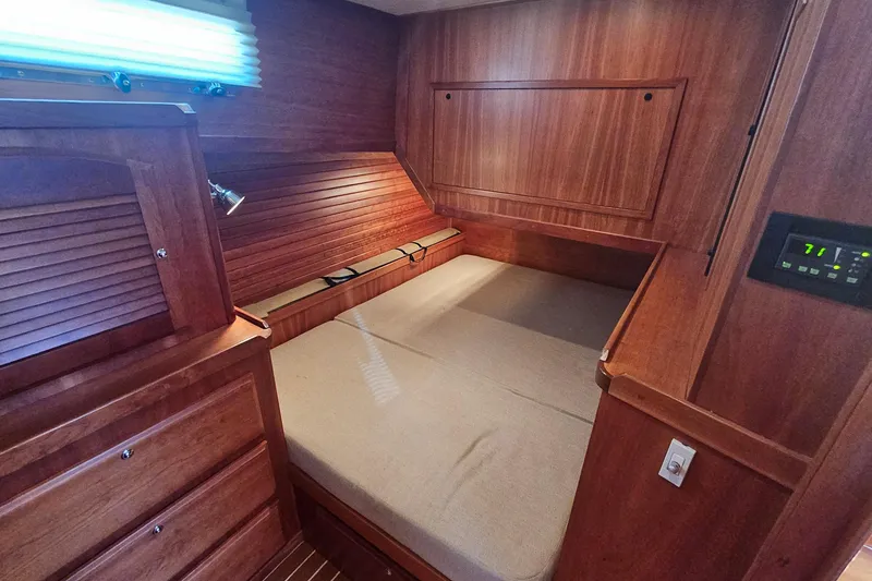Slide: The Image of Interior of 2009 Sabre 42 Express yacht with wooden table and plaid cushions. - 38