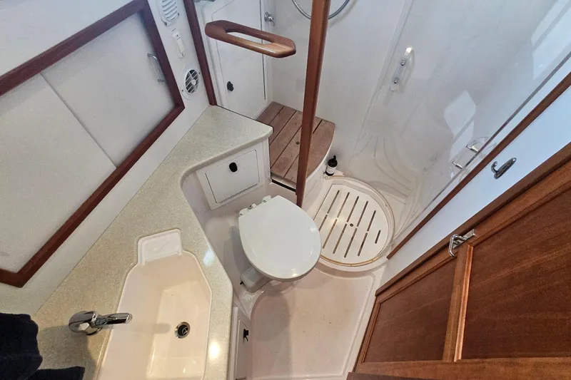Slide: The Image of 2009 Sabre 42 Express interior with wooden cabinetry and built-in refrigerator. - 41