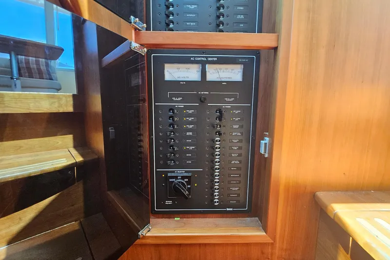 Slide: The Image of Electrical control panel inside 2009 Sabre 42 Express yacht, featuring switches and meters. - 49