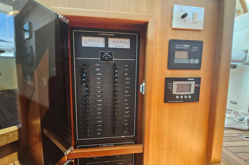 Slide: The Image of Electrical control panel on a 2009 Sabre 42 Express yacht, featuring gauges and switches. - 50