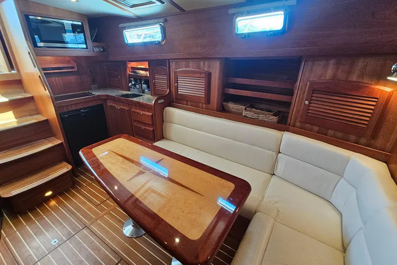 Slide: The Image of Luxurious interior of 2009 Sabre 42 Express yacht with elegant wood finishes and cozy seating. - 52