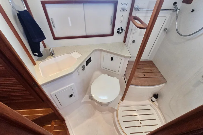 Slide: The Image of 2009 Sabre 42 Express yacht bathroom with sink, toilet, and shower area. - 62