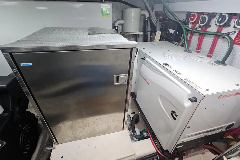 Slide: The Image of Engine room of 2009 Sabre 42 Express with Cummins Onan generator and equipment. - 68