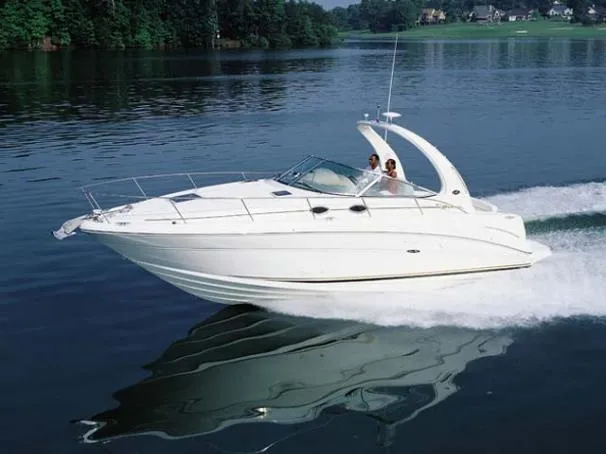 The Image of 2005 Sea Ray 300 Sundancer docked in a marina, covered and ready for use. - 0