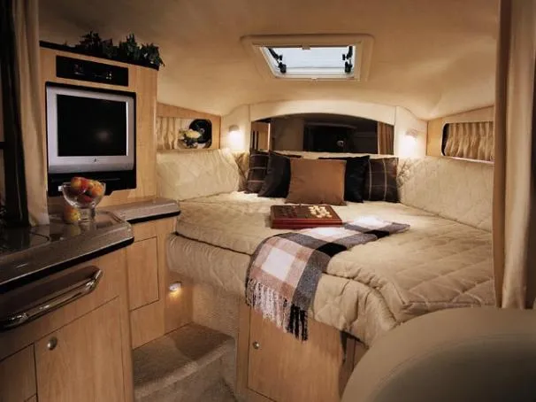 Slide: The Image of 2005 Sea Ray 300 Sundancer docked at marina, covered with blue canopy. - 1